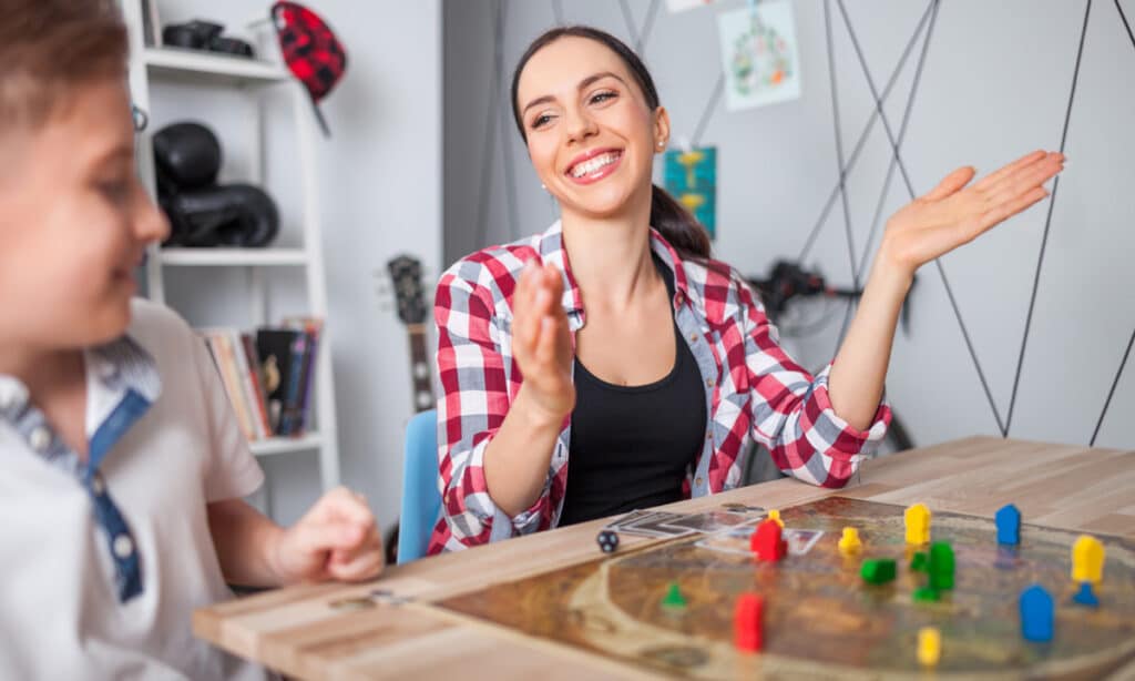 An adult and child playing a board game